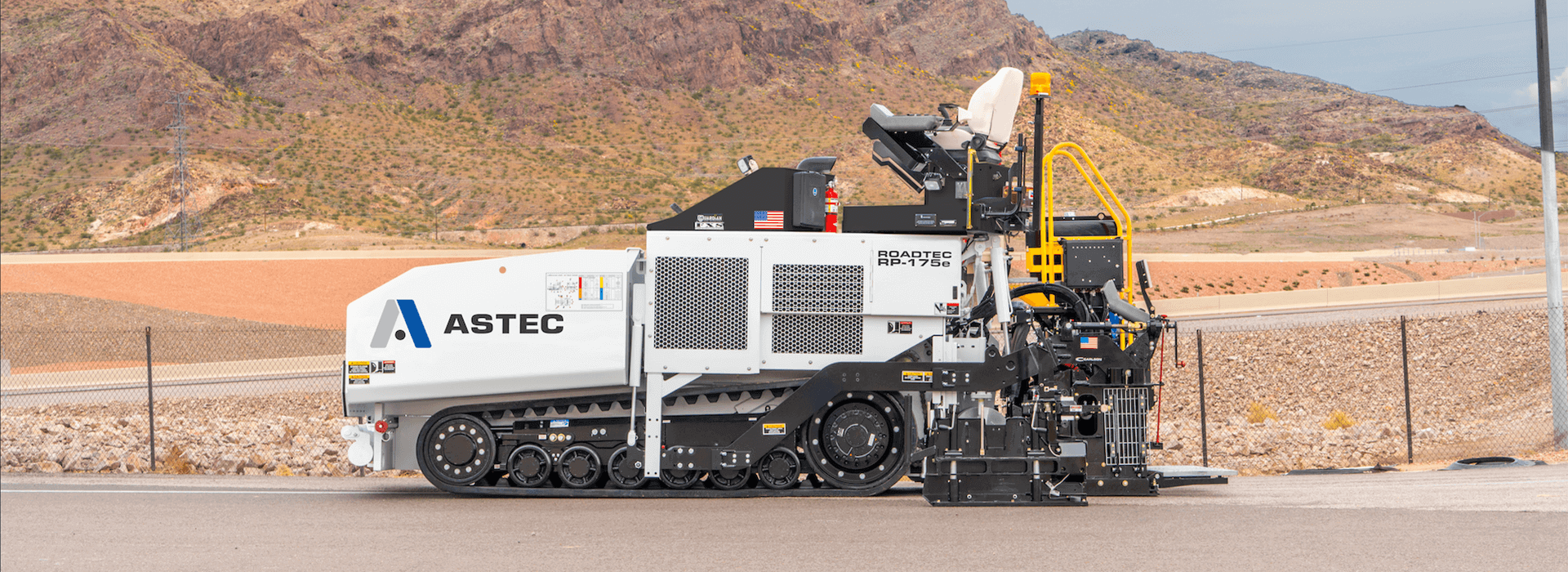 Roadtec RP-175 highway class asphalt paver on road with mountains in the background