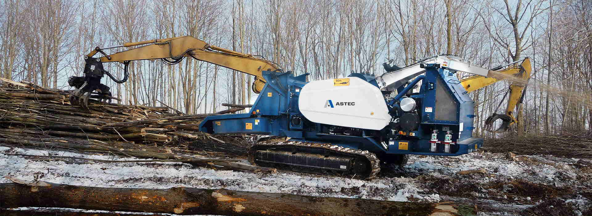 Peterson 4310B Highwalker Drum Chipper land clearing a right-of-way in the snow.