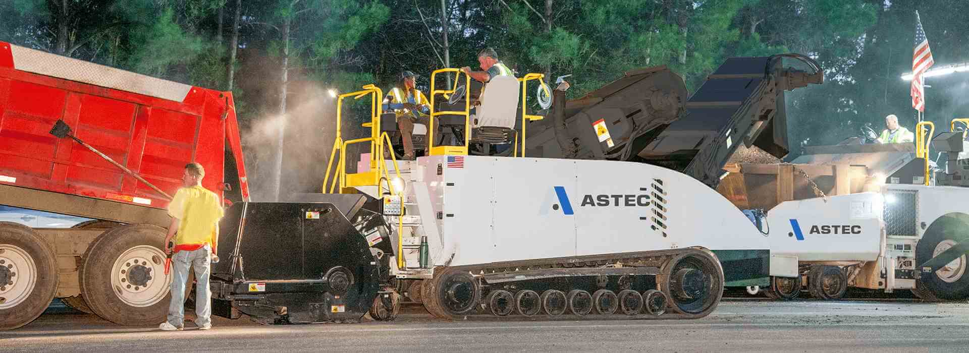 A Roadtec MTV-1105 material transfer vehicle working with a roadtec RP-190 paver